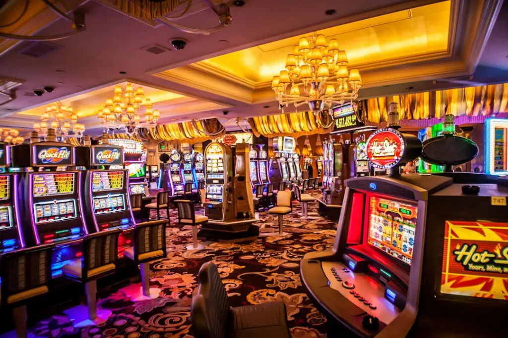 Row of slot machines with bright lights, illustrating high volatility slots